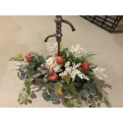 Tin with faucets greenery and white flowers